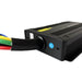 A close-up of the Trolltek™ 40Amp DC/DC Charger with MPPT Solar Input by Trolltek, a black electronic device featuring colorful wires, a blue QC PASSED reset button, and vented grooves on its casing—ideal as a marine battery charger or DC to DC lithium battery charger.