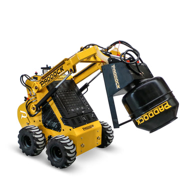 A yellow mini loader by Scintex, featuring hydraulic couplings, is paired with the Paddock Cement Mixer Attachment. Its large tires and angled stance emphasize the mechanical arm of this mixer attachment, highlighting its sturdy hydraulic components.