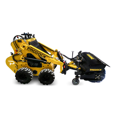 A Paddock Road Sweeper by Scintex is showcased on a white background, highlighting its industrial versatility. This yellow mini loader, equipped with multiple wheels and diverse controls, is ready to tackle any task.